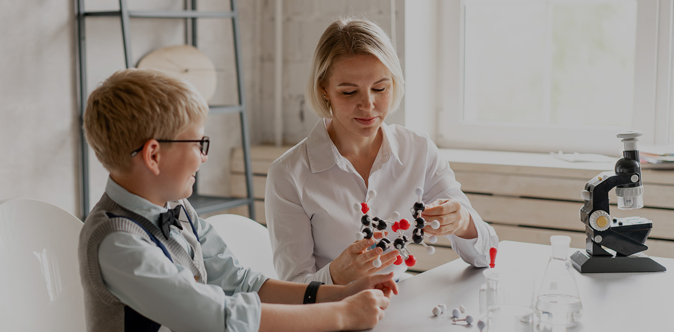 Female science tutor in Ann Arbor studying chemistry with student